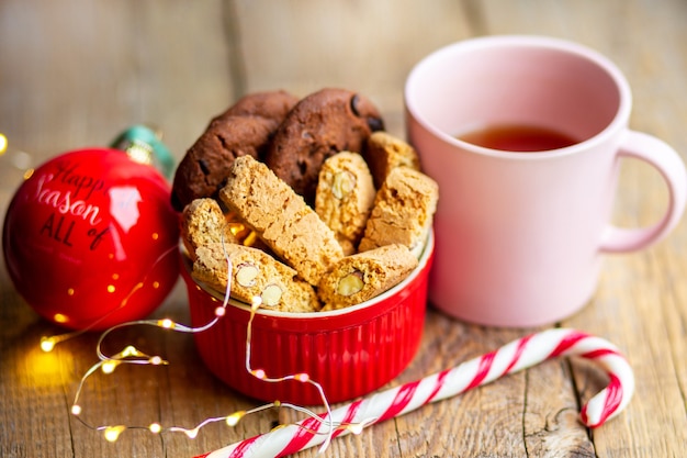 Caramelle di Natale con un giocattolo sull'albero Bevanda calda con biscotti al cioccolato Fuoco del Bengala in una tazza