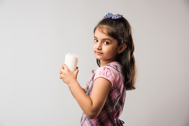 Carina ragazza indiana o asiatica con in mano un bicchiere pieno di latte - concetto di alimentazione sana