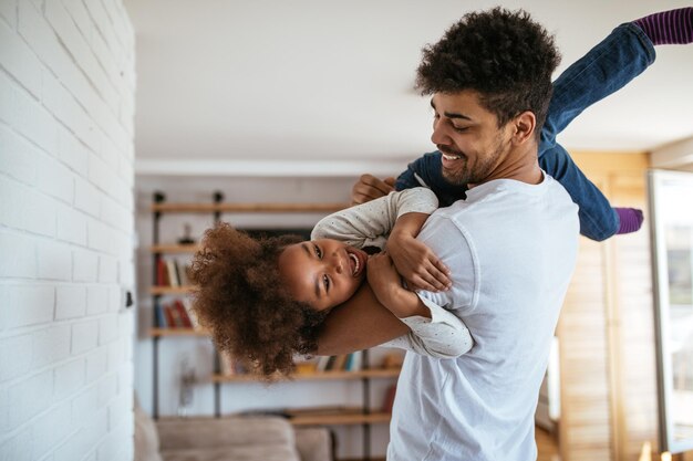 Carino bambino afroamericano che gioca con suo padre