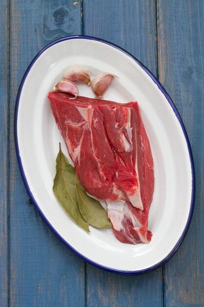 Carne cruda con aglio sul piatto bianco