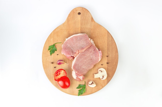 Carne cruda Pezzi di bistecche di manzo cruda con ingridients sul tagliere Concetto di preparazione del cibo