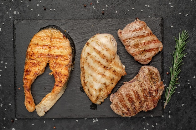 carne e pesce alla griglia con spezie su fondo di pietra