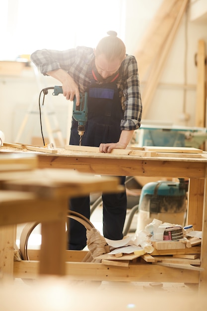 Carpenter Drilling Wood