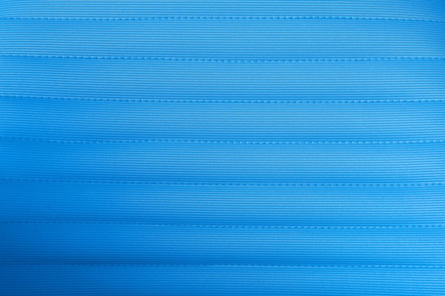 Carta da parati blu del fondo del tappeto del primo piano