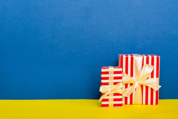 Carta per le vacanze presente legata con fiocco giallo nastro vista dall'alto con spazio per la copia Sfondo vacanza piatto laico Compleanno o regalo di Natale Concetto di confezione regalo di Natale con spazio per la copia