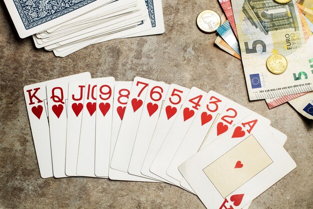 Carte da poker e soldi su un tavolo di legno