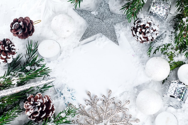 Cartolina di Natale con albero di abete decorato sulla neve.