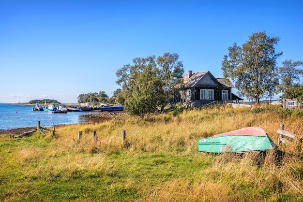 Casa in legno sulle rive del Mar Bianco sulle isole Solovetsky e navi al molo