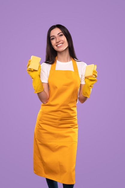 Casalinga sorridente con le spugne pronte per i lavori domestici