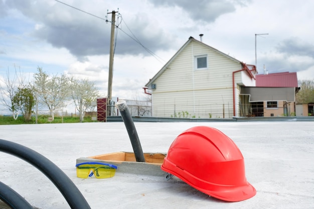 Casco della costruzione del fondamento del cottage ad un cantiere. Costruzione di una nuova casa