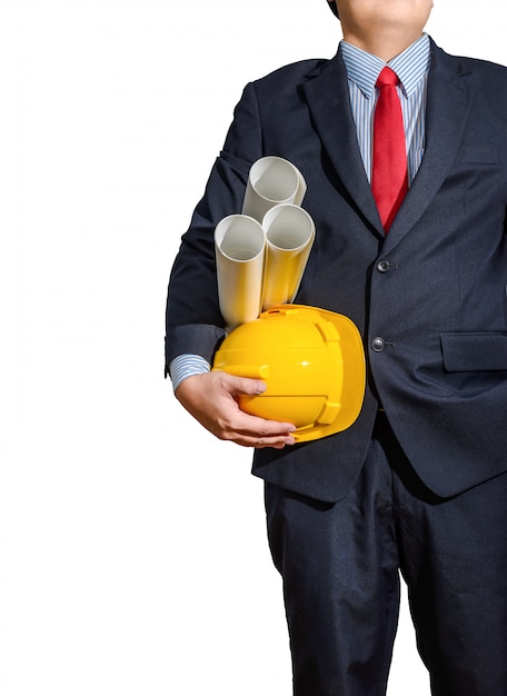 Casco giallo dell&#39;ingegnere per sicurezza dei lavoratori con i piani della costruzione isolati