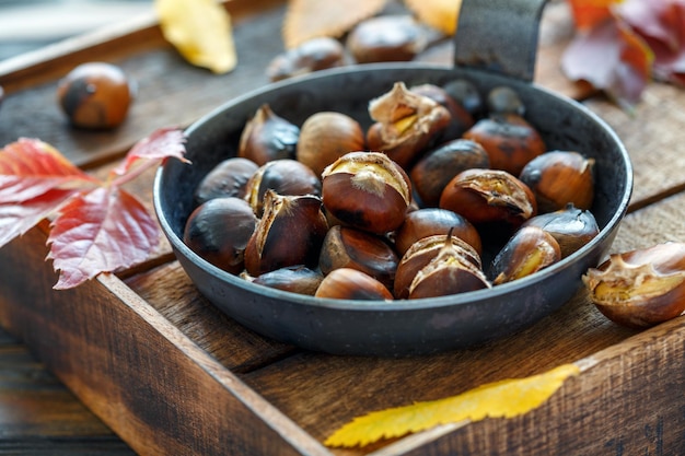 Castagne arrostite in una padella di ghisa