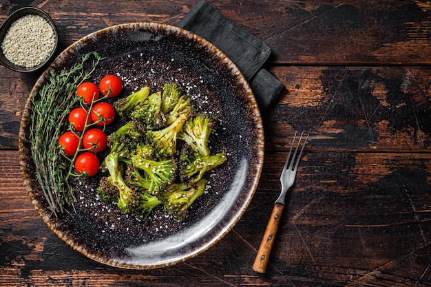 Cavolo broccoli arrosto alla griglia con erbe su piastra Sfondo in legno Vista dall'alto Spazio di copia