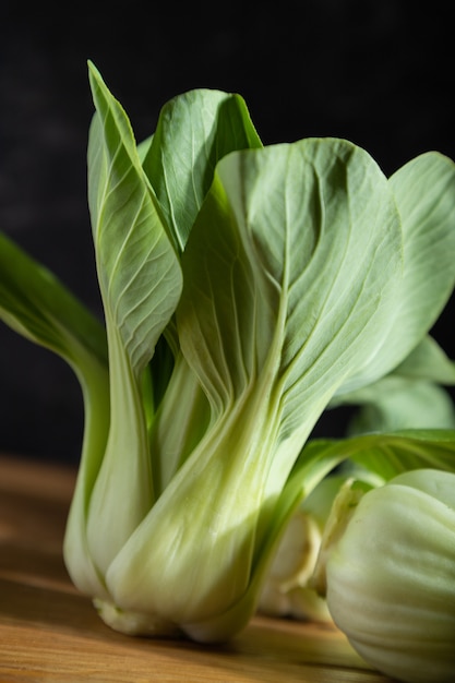 Cavolo cinese fresco bok choy o pac choi su una superficie di legno grigia