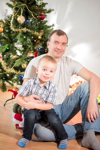 Celebrazione di Natale Famiglia in camera con albero di Natale