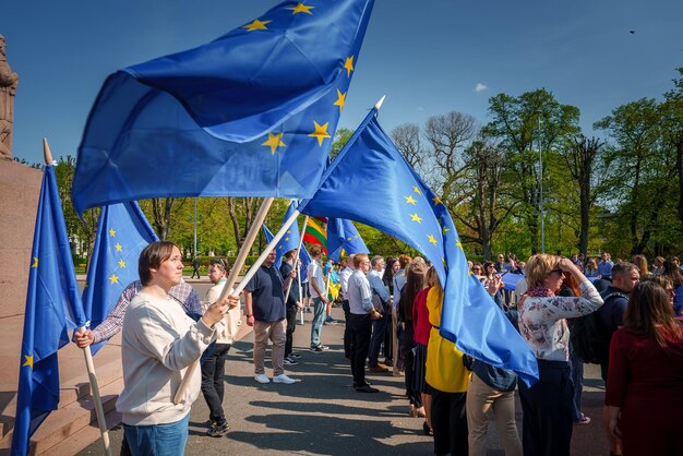 Celebrazione nella città vecchia di Riga, Lettonia, festa con la bandiera dell'UE sventolata dalla folla