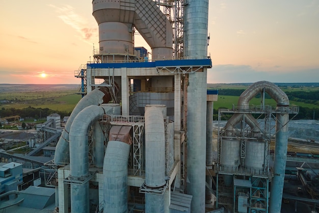 Cemento con struttura di fabbrica alta e gru a torre nell'area di produzione industriale Fabbricazione di industria globale e concetto di inquinamento atmosferico