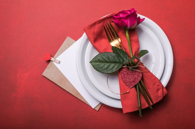 Cena di San Valentino con decorazione di cuori per la tavola, rosa per la cena di San Valentino. Vista dall'alto.