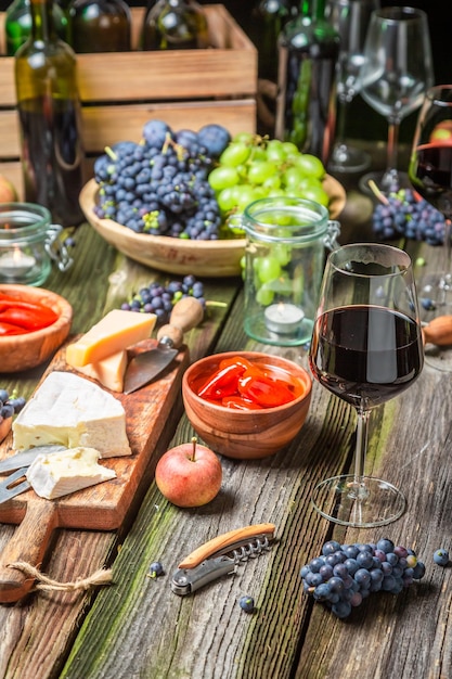 Cena sulla vecchia tavola di legno con stuzzichini e vino