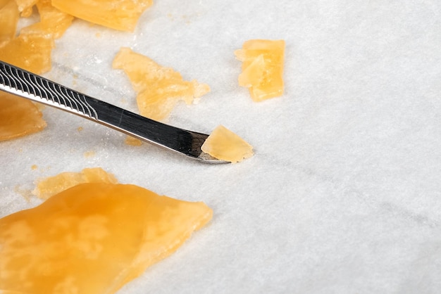 Cera concentrata di cannabis giallo arancio da vicino su resina dab ad alto contenuto di thc