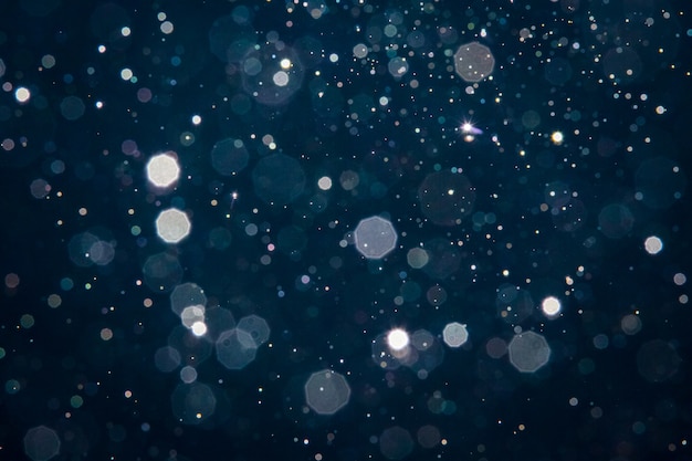 Cerchi blu astratti del bokeh della sfuocatura leggera per il fondo di Natale