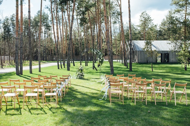 Cerimonia all'aperto molto bella matrimonio classico in arco di metallo foresta con fiori