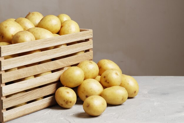 Cesto con patate novelle su sfondo grigio. posto per il testo