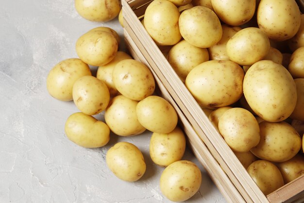 Cesto con patate novelle su sfondo grigio. posto per il testo