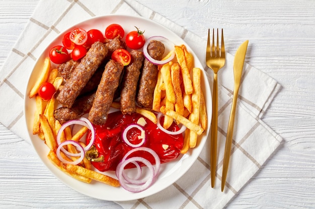 Cevapcici con patate fritte pomodori peperoncini