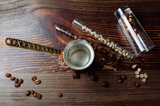 Cezve di caffè e chicchi di caffè su fondo in legno Flat lay