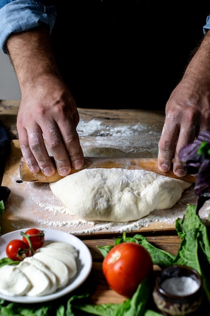 chef italiano che cucina la pizza mani dell'uomo che cucinano la pasta della pizza per la pizza