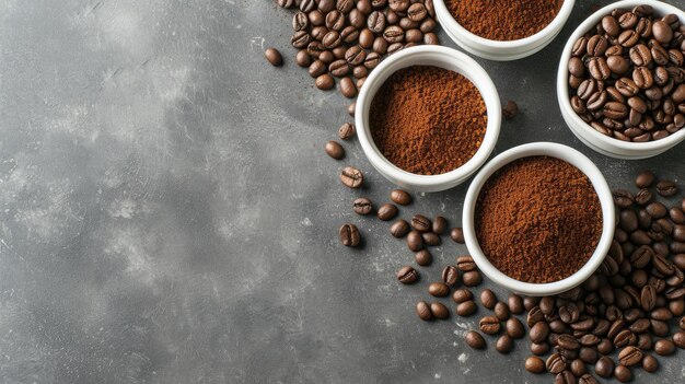 chicchi di caffè e caffè macinato in piastre bianche su uno sfondo grigio che offrono una vista dall'alto con ampio spazio per la copia