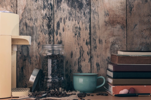 Chicchi di caffè e libri sul tavolo.