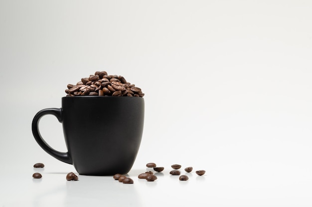 Chicchi di caffè in primo piano nero della tazza