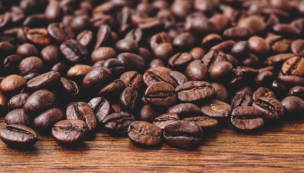 Chicchi di caffè tostati sul vecchio tavolo di legno