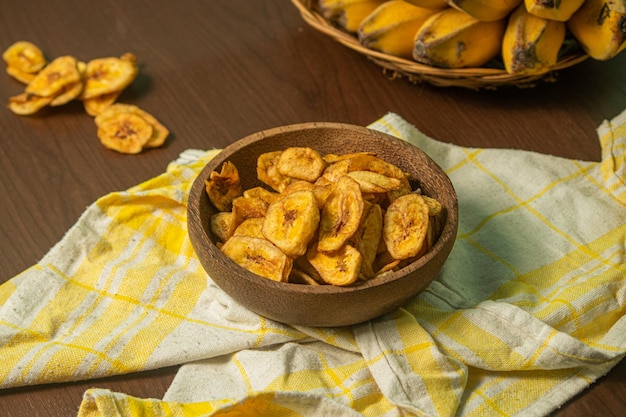 Chip di banana croccanti e deliziose su uno sfondo di legno