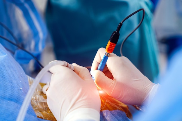 Chirurgo in sala operatoria con attrezzatura chirurgica Processo professionale di chirurgia