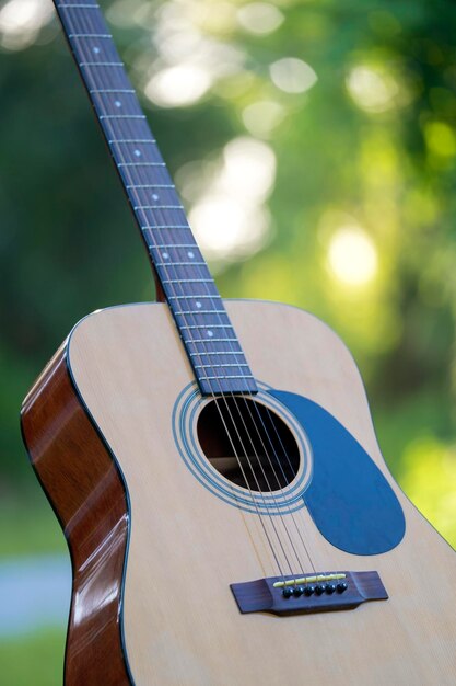 Chitarra acustica all'aperto su sfondo verde Concetto di musica calma