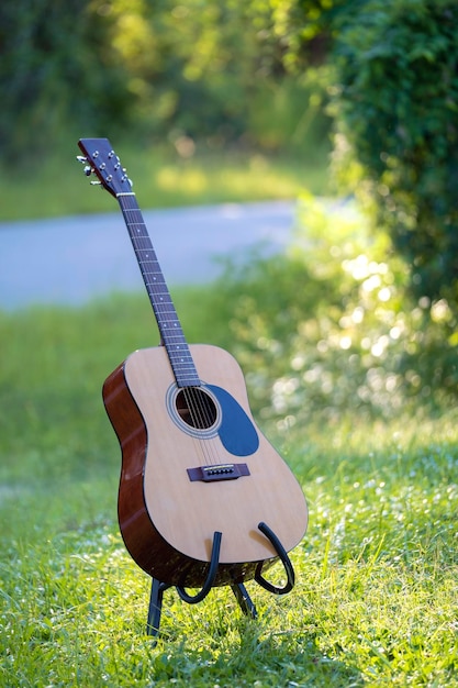 Chitarra acustica all'aperto su sfondo verde Concetto di musica calma