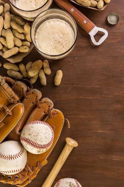 Chiuda in su della vecchia attrezzatura da baseball usurata su uno sfondo di legno.