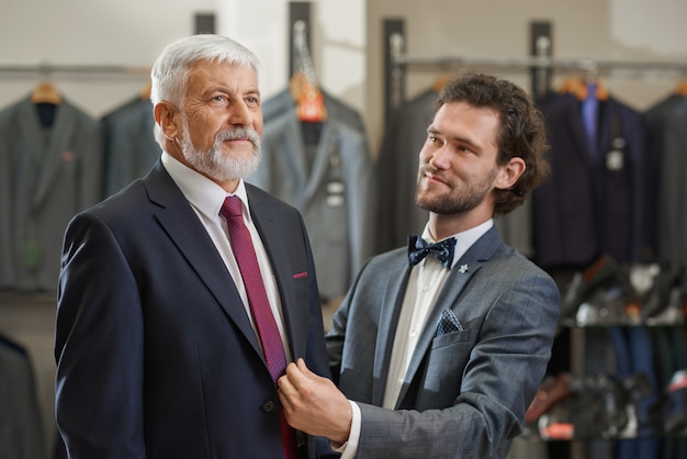 Chiuda in su di due uomini eleganti che vengono alla boutique sullo shopping.