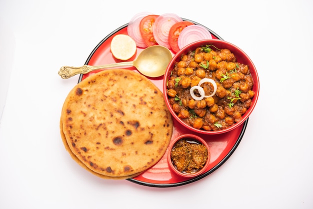 Chole con Aloo Paratha o Alu parantha, popolare ricetta alimentare dell'India settentrionale servita calda con sottaceti di mango