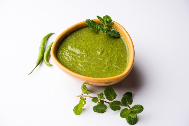 Chutney di menta verde sano fatto con coriandolo, pudina e spezie. sfondo lunatico isolato. messa a fuoco selettiva