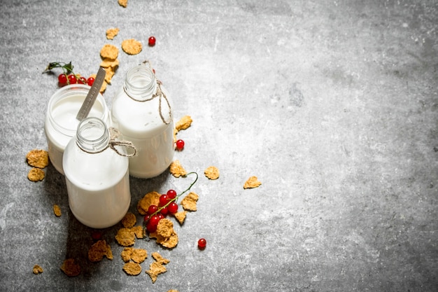 Cibo fitness. Latte con cereali e frutti di bosco. Sul tavolo di pietra.