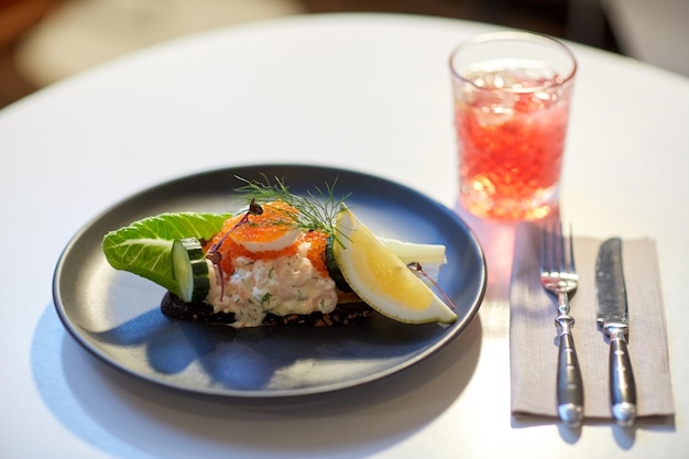 cibo, nuova cucina nordica e concetto di cucina - primo piano di toast skagen con gamberetti, maionese al limone, uova di pesce e pane burroso sul piatto