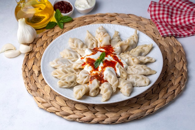 Cibo tradizionale manti sul piatto, vista dall'alto. Il concetto di cucina orientale. Gnocchi di cibo uzbeko. (nome turco; hinkel mantisi)