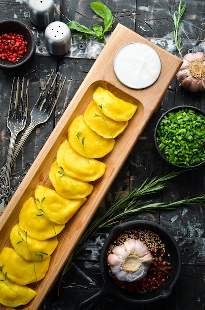 Cibo tradizionale ucraino Gnocchi di patate gialle con panna acida Vista dall'alto Stile rustico