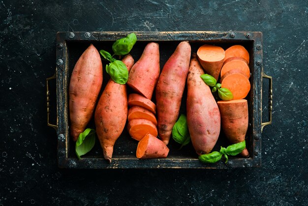 Cibo vegano Patate dolci in una scatola di legno Vista dall'alto Spazio libero per il testo