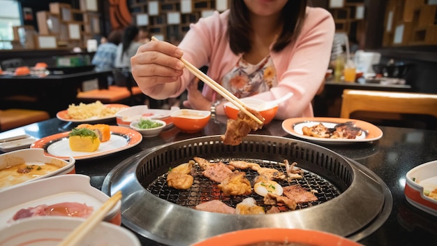 Cibo Yakiniku Versione giapponese del barbecue coreano Carne cruda su un piatto e carne alla griglia con salsa