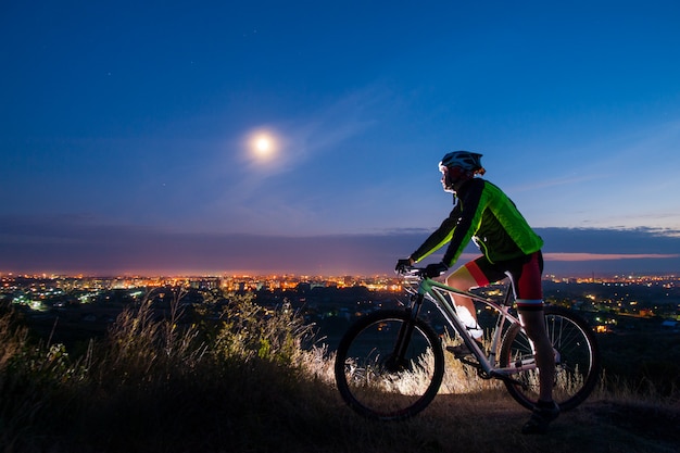 Ciclista con mountain bike in cima alla collina